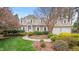 Charming traditional home featuring a well-manicured lawn, blooming trees, and inviting curb appeal at 8 Bryncastle Ct, Durham, NC 27707