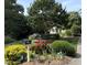 Charming front yard featuring lush landscaping, colorful flowers, and a neatly maintained lawn, enhancing curb appeal at 8 Bryncastle Ct, Durham, NC 27707