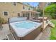 Backyard hot tub beside a deck with outdoor seating, perfect for relaxing and entertaining in style at 8 Bryncastle Ct, Durham, NC 27707