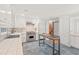Bright kitchen with stainless steel appliances, light tile flooring, and a barn door entrance to the pantry at 8 Bryncastle Ct, Durham, NC 27707