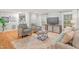 Comfortable living room featuring hardwood floors, large windows, and a neutral color scheme at 8 Bryncastle Ct, Durham, NC 27707