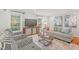 Inviting living room with natural light, a comfortable sofa, and stylish armchairs at 8 Bryncastle Ct, Durham, NC 27707