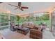 Sunroom with ample seating, a ceiling fan, and lots of natural light flooding in from the surrounding backyard at 8 Bryncastle Ct, Durham, NC 27707