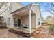 Relaxing covered back patio with comfortable seating and serene backyard views, perfect for outdoor living at 8412 Lunar Stone Pl, Raleigh, NC 27613