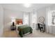 Well-lit bedroom featuring a bed, desk, chair and multiple windows at 8412 Lunar Stone Pl, Raleigh, NC 27613