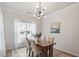 Cozy dining room with modern lighting and a window at 8412 Lunar Stone Pl, Raleigh, NC 27613