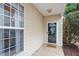 Charming front entrance featuring a black door, window, and well-maintained siding at 8412 Lunar Stone Pl, Raleigh, NC 27613