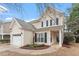 Inviting home with a two-car garage, manicured front lawn, and cozy front porch at 8412 Lunar Stone Pl, Raleigh, NC 27613