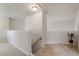 Well-lit hallway featuring carpeted floor, banister and staircase at 8412 Lunar Stone Pl, Raleigh, NC 27613