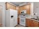 Well-equipped kitchen featuring appliances and wooden cabinets at 8412 Lunar Stone Pl, Raleigh, NC 27613