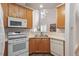 Well-lit kitchen featuring stainless steel appliances, light wood cabinetry, and ample counter space at 8412 Lunar Stone Pl, Raleigh, NC 27613