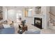 Comfortable living room with fireplace and view into dining area at 8412 Lunar Stone Pl, Raleigh, NC 27613