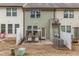 Townhome backyard and patio with seating, small patch of grass, and fence at 9845 Sweet Basil Dr, Wake Forest, NC 27587