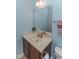 Bathroom featuring a vanity with a sink, mirror, and neutral decor at 9845 Sweet Basil Dr, Wake Forest, NC 27587