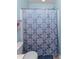 This is a bathroom with a blue and white shower curtain and white toilet at 9845 Sweet Basil Dr, Wake Forest, NC 27587