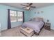 Comfortable bedroom with a ceiling fan, natural light, and neutral decor, creating a cozy atmosphere at 9845 Sweet Basil Dr, Wake Forest, NC 27587