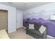 Cozy bedroom with stylish gray couch, mountain mural, and natural light at 9845 Sweet Basil Dr, Wake Forest, NC 27587