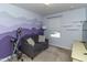 A vibrant bedroom featuring a stylish couch, exercise bike, and a unique mountain wall at 9845 Sweet Basil Dr, Wake Forest, NC 27587