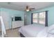 Spacious bedroom features a large bed, a dresser with a TV, and ample natural light from the windows at 9845 Sweet Basil Dr, Wake Forest, NC 27587