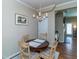 Cozy dining room features a round wooden table with seating for four and a charming chandelier at 9845 Sweet Basil Dr, Wake Forest, NC 27587