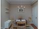 Charming dining area showcases a round wooden table with four chairs under a chandelier at 9845 Sweet Basil Dr, Wake Forest, NC 27587