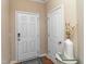 Welcoming entryway featuring a white front door, interior door, and decorative vase at 9845 Sweet Basil Dr, Wake Forest, NC 27587