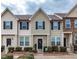 Charming townhouse featuring a neatly landscaped front yard and complementary exterior color scheme at 9845 Sweet Basil Dr, Wake Forest, NC 27587