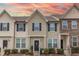 Charming townhouse featuring a neatly landscaped front yard and complementary exterior color scheme at 9845 Sweet Basil Dr, Wake Forest, NC 27587