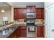 Well-equipped kitchen with stainless steel appliances, granite countertops, and ample cabinet space at 9845 Sweet Basil Dr, Wake Forest, NC 27587