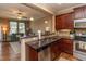 Open kitchen featuring granite countertops, stainless steel appliances, and access to the living area at 9845 Sweet Basil Dr, Wake Forest, NC 27587