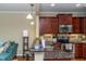 Open kitchen featuring granite countertops, stainless steel appliances, and breakfast bar at 9845 Sweet Basil Dr, Wake Forest, NC 27587