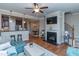 Open-concept living space with a fireplace, kitchen bar, and dining area at 9845 Sweet Basil Dr, Wake Forest, NC 27587