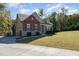 Beautiful two-story home with a stone and brick facade and a well-manicured lawn at 1001 Jarrett Bay Rd, Willow Springs, NC 27592