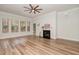 Bright living room with hardwood floors, a cozy fireplace, and large windows at 1001 Jarrett Bay Rd, Willow Springs, NC 27592