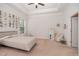 Cozy bedroom with neutral decor, tray ceilings, and soft carpet, perfect for relaxation at 1001 Jarrett Bay Rd, Willow Springs, NC 27592