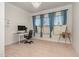 Bright home office with large windows, neutral carpet, and a sleek desk setup at 1001 Jarrett Bay Rd, Willow Springs, NC 27592