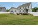 Large backyard features a well-manicured lawn, a cozy patio, mature plants, and a covered porch at 1001 Peterson Ridge Rd, Fuquay Varina, NC 27526