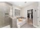 Bright bathroom with a soaking tub, glass-enclosed shower, and access to a walk-in closet at 1001 Peterson Ridge Rd, Fuquay Varina, NC 27526