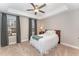 Inviting bedroom with large windows, plush carpet, and a decorative ceiling fan at 1001 Peterson Ridge Rd, Fuquay Varina, NC 27526