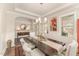 Stylish dining room with a dark wood table, light-colored chairs, and a view into other living areas at 1001 Peterson Ridge Rd, Fuquay Varina, NC 27526