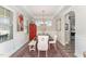 Elegant dining room with tray ceiling, red accent cabinet, area rug, and wainscoting at 1001 Peterson Ridge Rd, Fuquay Varina, NC 27526