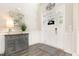 Bright foyer featuring wood floors, a decorative table with lamp, and a white front door at 1001 Peterson Ridge Rd, Fuquay Varina, NC 27526