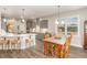 Open-concept kitchen with gray cabinets, white countertops, and dining area with wooden table and chairs at 1001 Peterson Ridge Rd, Fuquay Varina, NC 27526