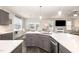 Modern kitchen featuring gray cabinets, white countertops and stainless steel appliances open to living spaces at 1001 Peterson Ridge Rd, Fuquay Varina, NC 27526