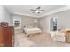 Spacious main bedroom with neutral tones, plush carpet, and an ensuite bathroom at 1001 Peterson Ridge Rd, Fuquay Varina, NC 27526