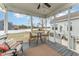 Inviting covered porch features a ceiling fan, outdoor seating and a view of the fenced backyard at 1001 Peterson Ridge Rd, Fuquay Varina, NC 27526