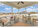 Relaxing covered porch with outdoor seating, ceiling fan and views of the fenced in yard at 1001 Peterson Ridge Rd, Fuquay Varina, NC 27526