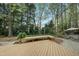 An outdoor space with green plants, a wood bench, and a table and chairs at 1007 Surry Dale Ct, Apex, NC 27502