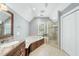 Large primary bathroom features a tub, glass shower, and large vanity with granite countertops at 1007 Surry Dale Ct, Apex, NC 27502
