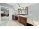 Bathroom with a double sink, long mirror, tile floor, and natural lighting at 1007 Surry Dale Ct, Apex, NC 27502